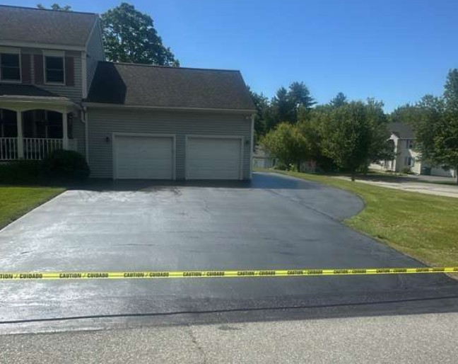 Driveway after sealcoating and crack filling application in Fitchburg, MA