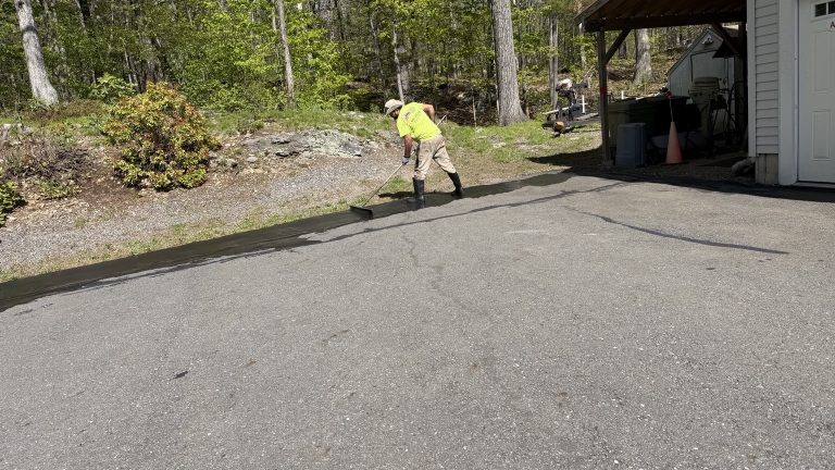 Lunenburg MA driveway sealcoating crew applying fresh sealcoat